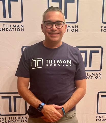 Erick Miyares posing in front of backdrop at Pat Tillman Scholar Summit July 2023