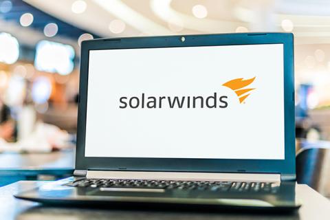 a laptop screen with the solarwinds logo on a white screen symbolizes one of the worst cyberattacks during covid 19