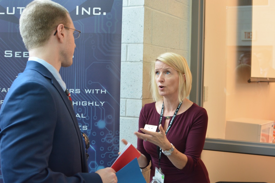 A student speaks with an employer representative at Capitol's Career Conference