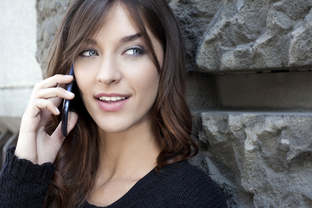 Stock photography of a woman using her mobile phone.