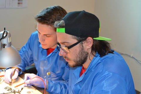 two astronautical engineering students working on Cubesat project 