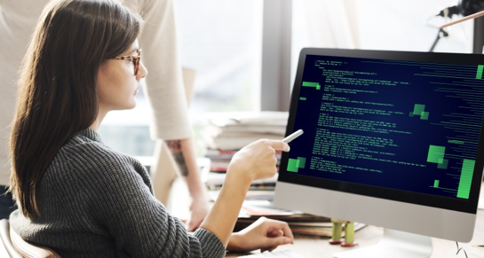 bachelor's in computer science student pointing to computer screen