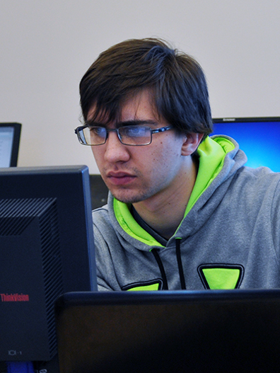 A cybersecurity student looking at a computer screen