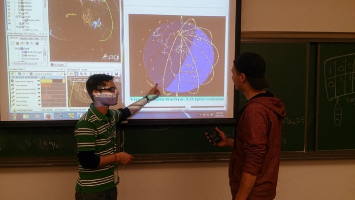 Capitol Tech student presenting aerospace related data chart to viewer