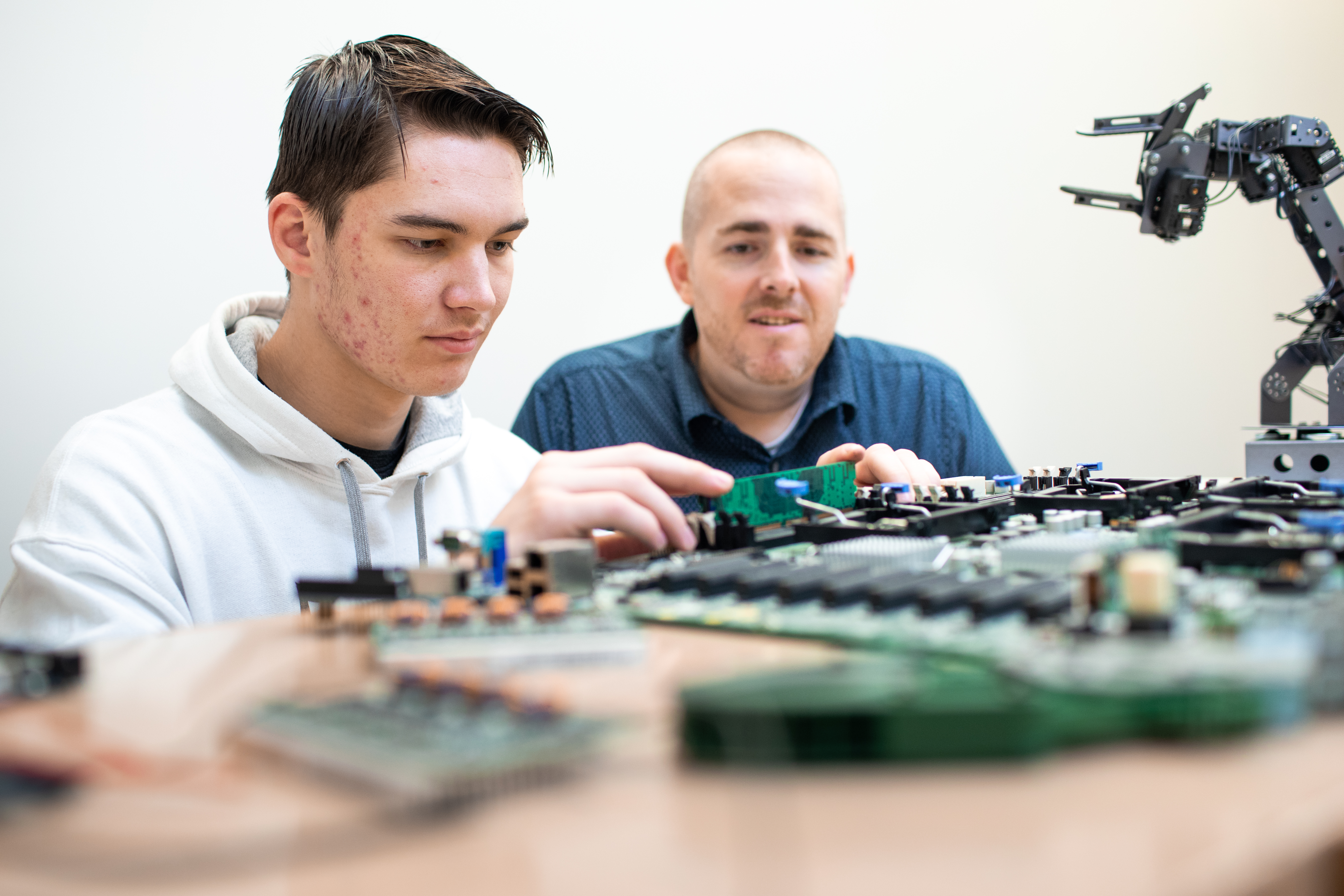 student and teacher working on robotics 