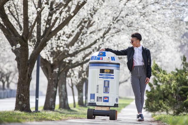 Girl walks with R2-D2