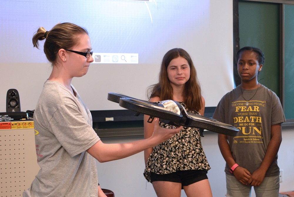 Students at science summer camp with drone