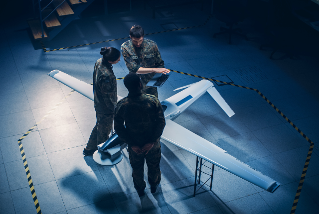 air force soldiers standing around drone prototype