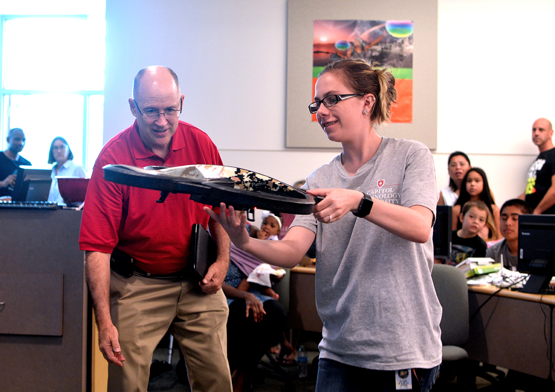 Capitol professor Rick Hansen and student Destinee Martin demonstrate a quadcopter