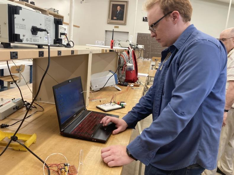 Cap Tech U Student Elijah Emory with Prof Hansen testing DEF CON 31 Badges