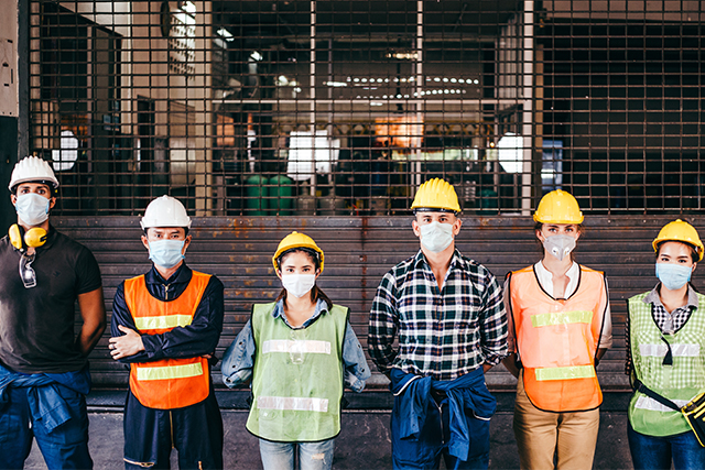 six people in hard hats, vests and masks demonstrate the impact of covid on construction industry and workers