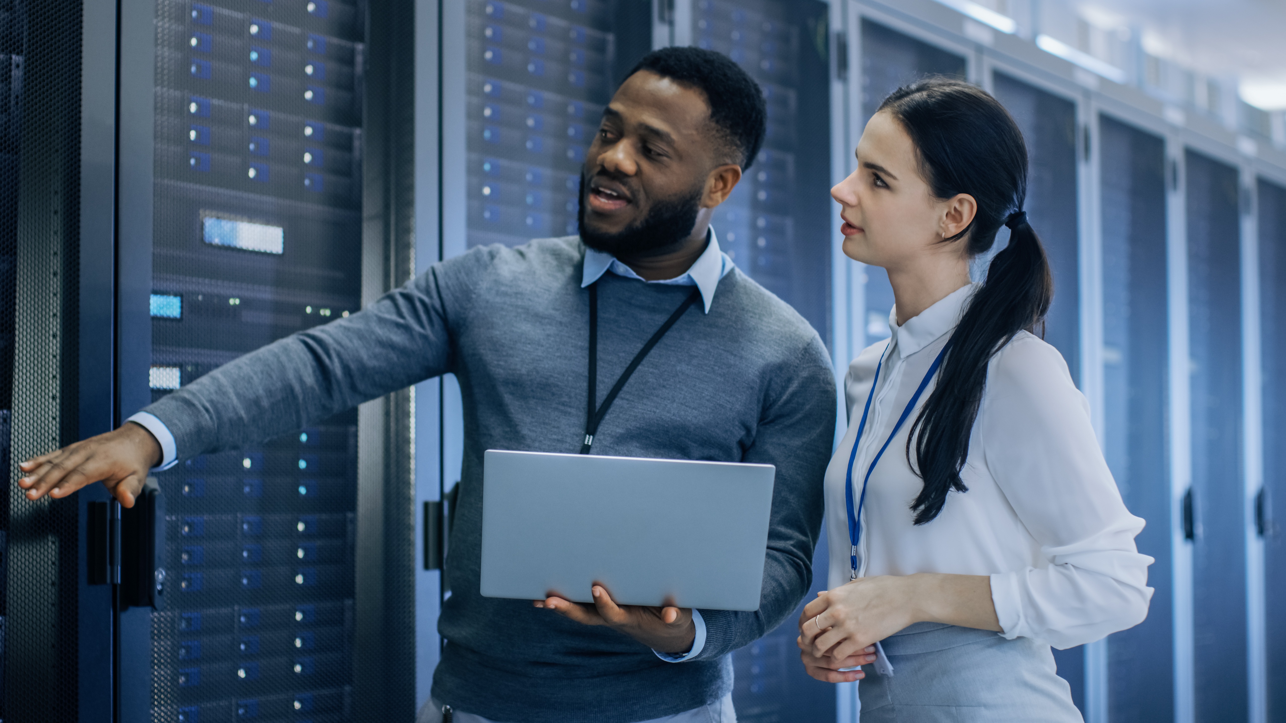 Man and woman standing in server room showing careers in cybersecurity in government