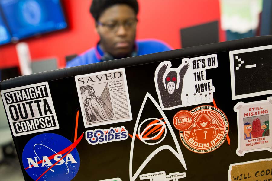 laptop with cyber stickers on lid