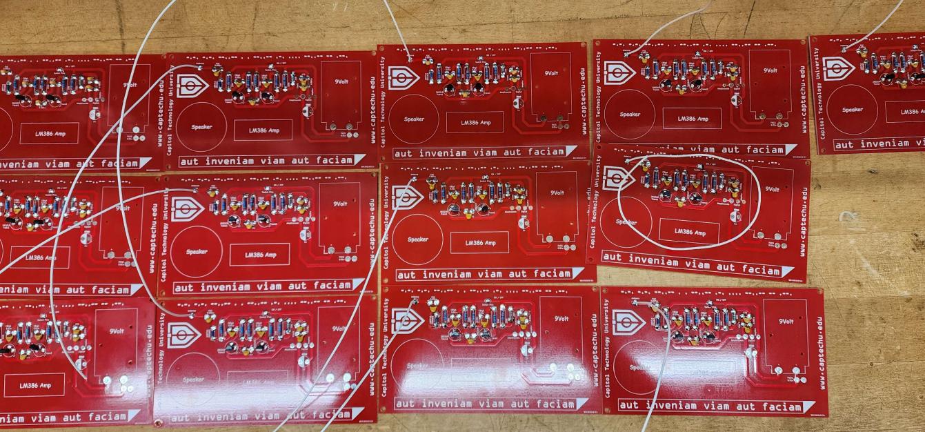Set of red DEF CON 31 badges in  production