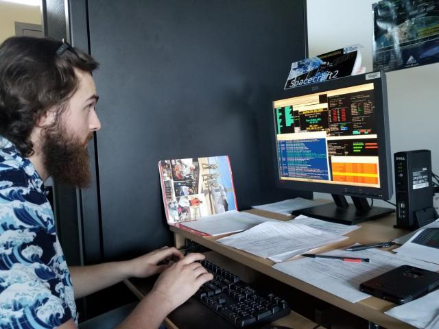 student working on computer in Space Flight Operations Training Center