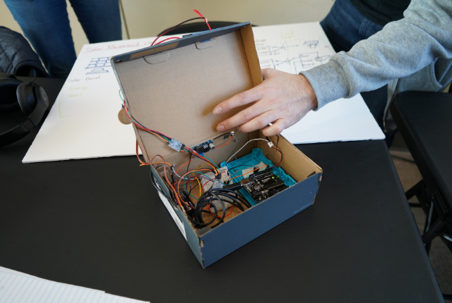 Student Showing Internal Circuitry of Sun-Tracker Solar Panel