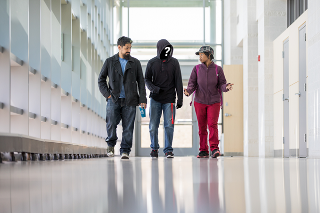 three students one has face concealed