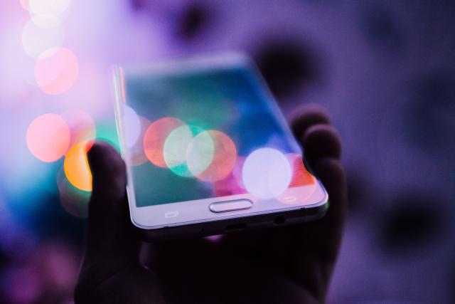 Hand holding phone symbolizing artificial intelligence voice technology