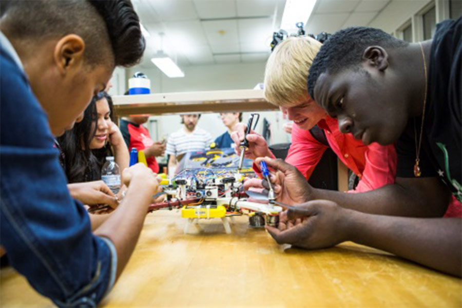 Capitol Tech students working on robotic models in the lab. 