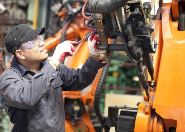 mechatronics engineer working on industrial robot