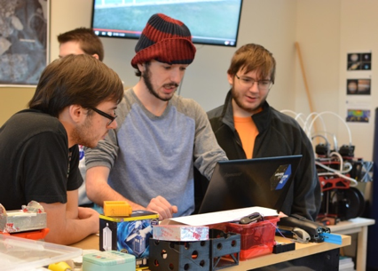 astronautical engineering students working in fusion lab