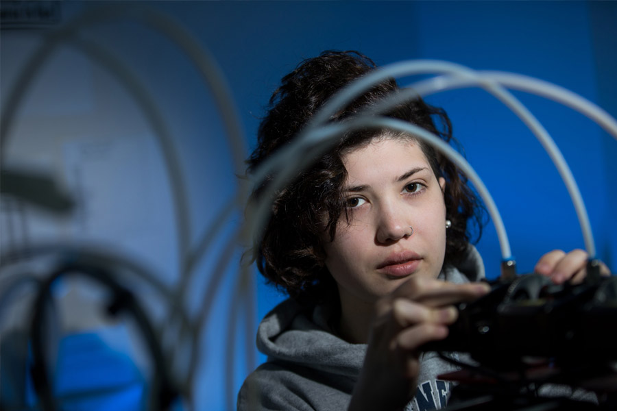 student in fusion lab working with 3D printer