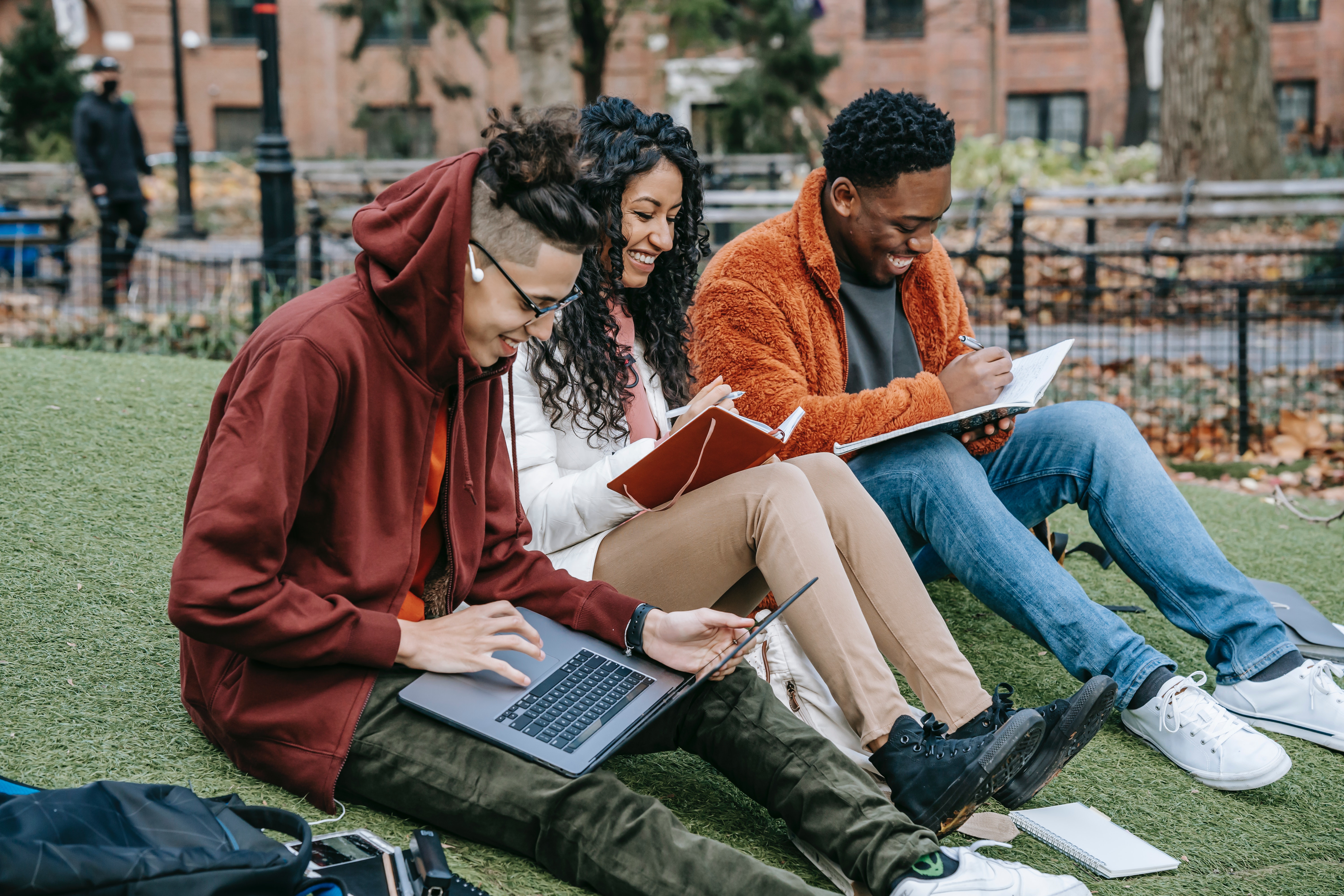 Diverse College Students on Cmapus Lawn Studying