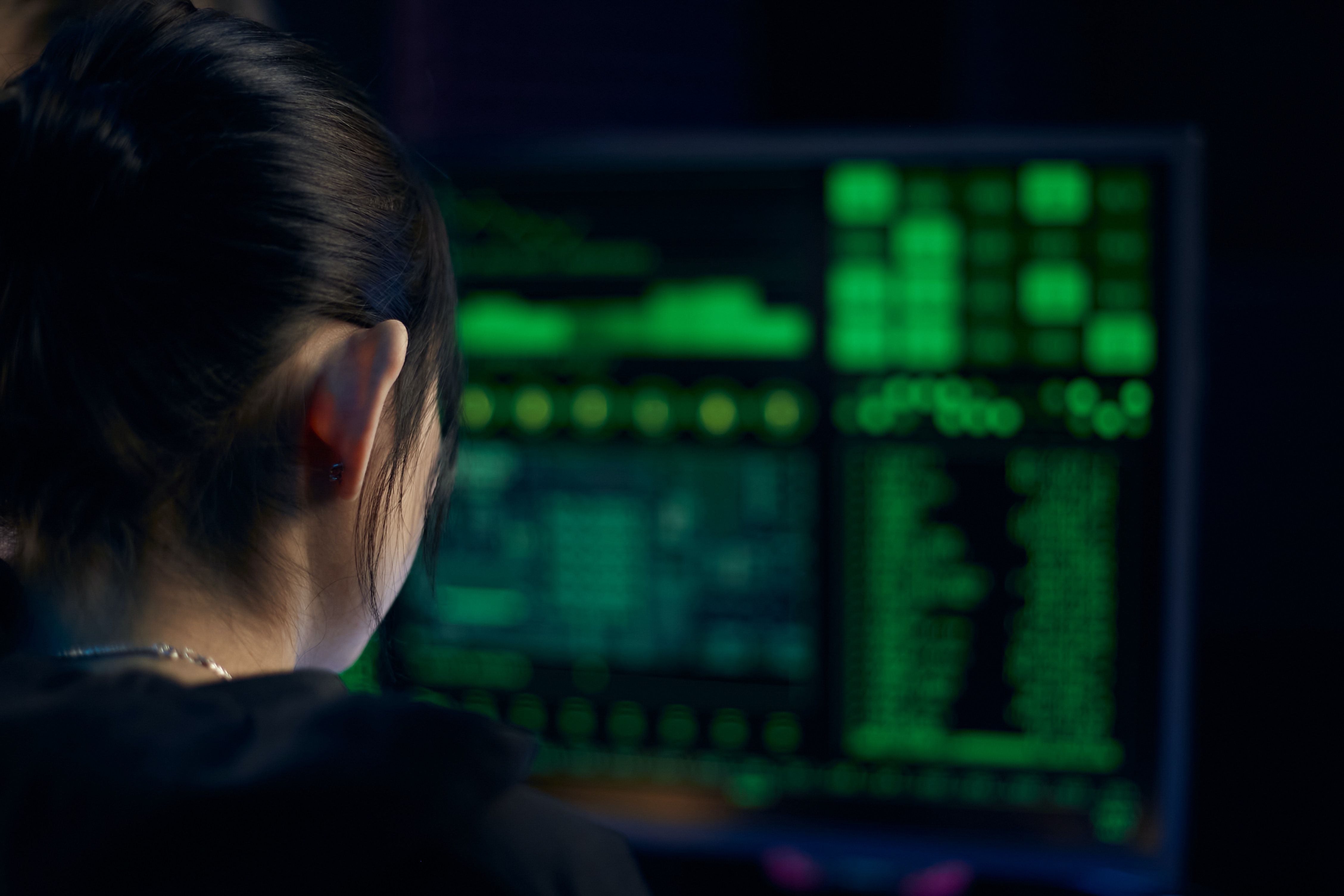 person facing computer screen displaying code