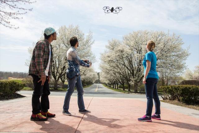Students flying drone on campus
