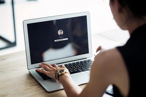 Stock image of a woman typing her computer password