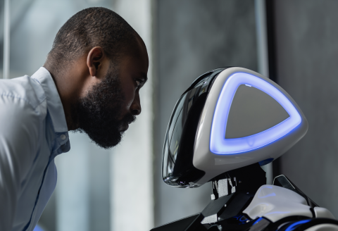 man looking at humanoid robot