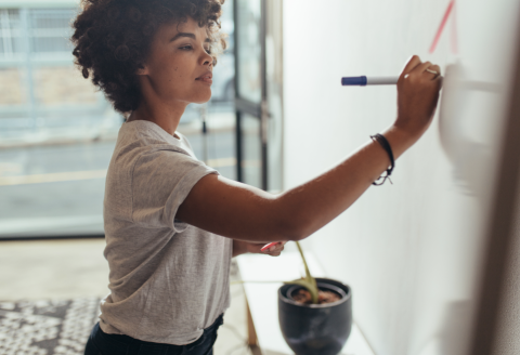 woman writing on whiteboard