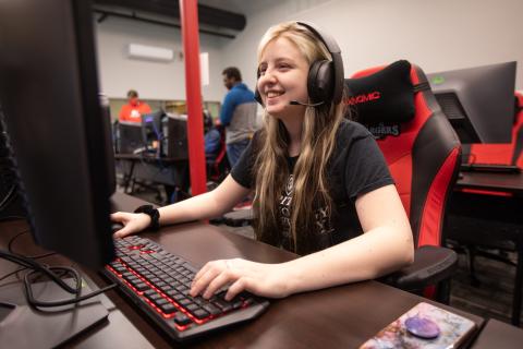 Young woman student smiling while on computer