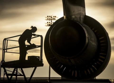 person works on airplane engine