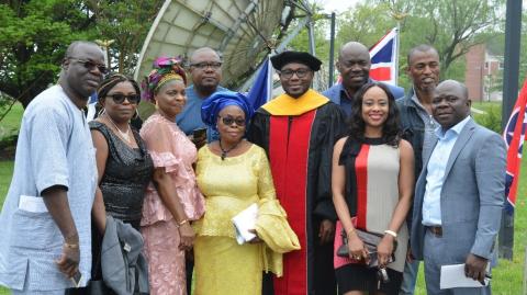 family poses with doctoral graduate
