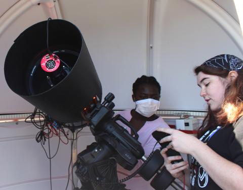 showing girl telescope