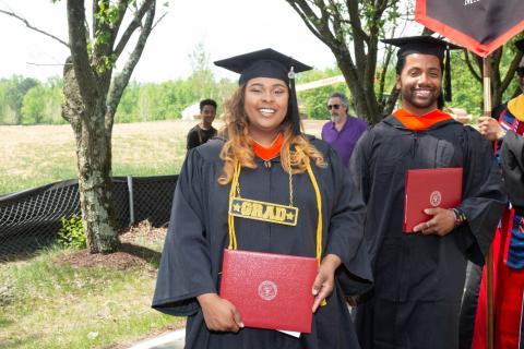 graduates hold their diplomas