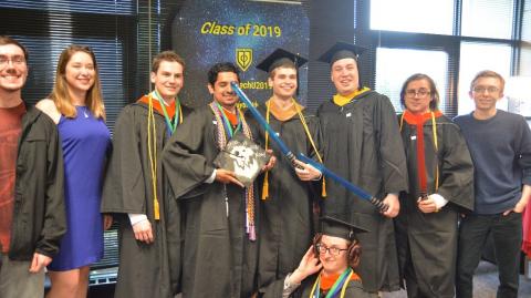 graduates pose in Star Wars photo booth