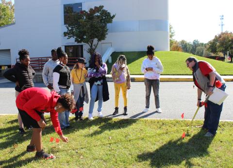 students measuring with flags