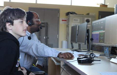 professor and student use computer together 