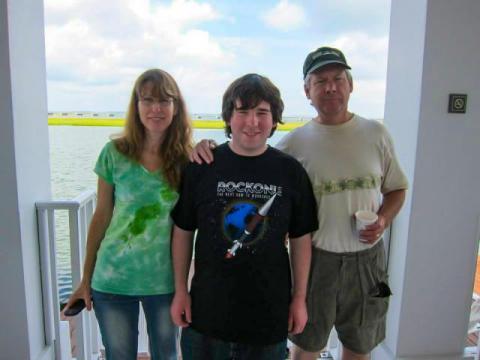 a portrait of Carl Hansen, who pursued a stem focused education, with his parents