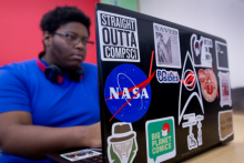 cyber analytics student working on laptop